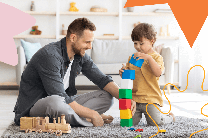 pai brincando com filho na sala de estar utilizando brinquedos de madeira
